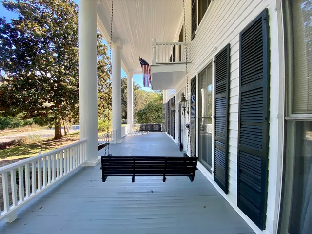 a room with pool table and windows