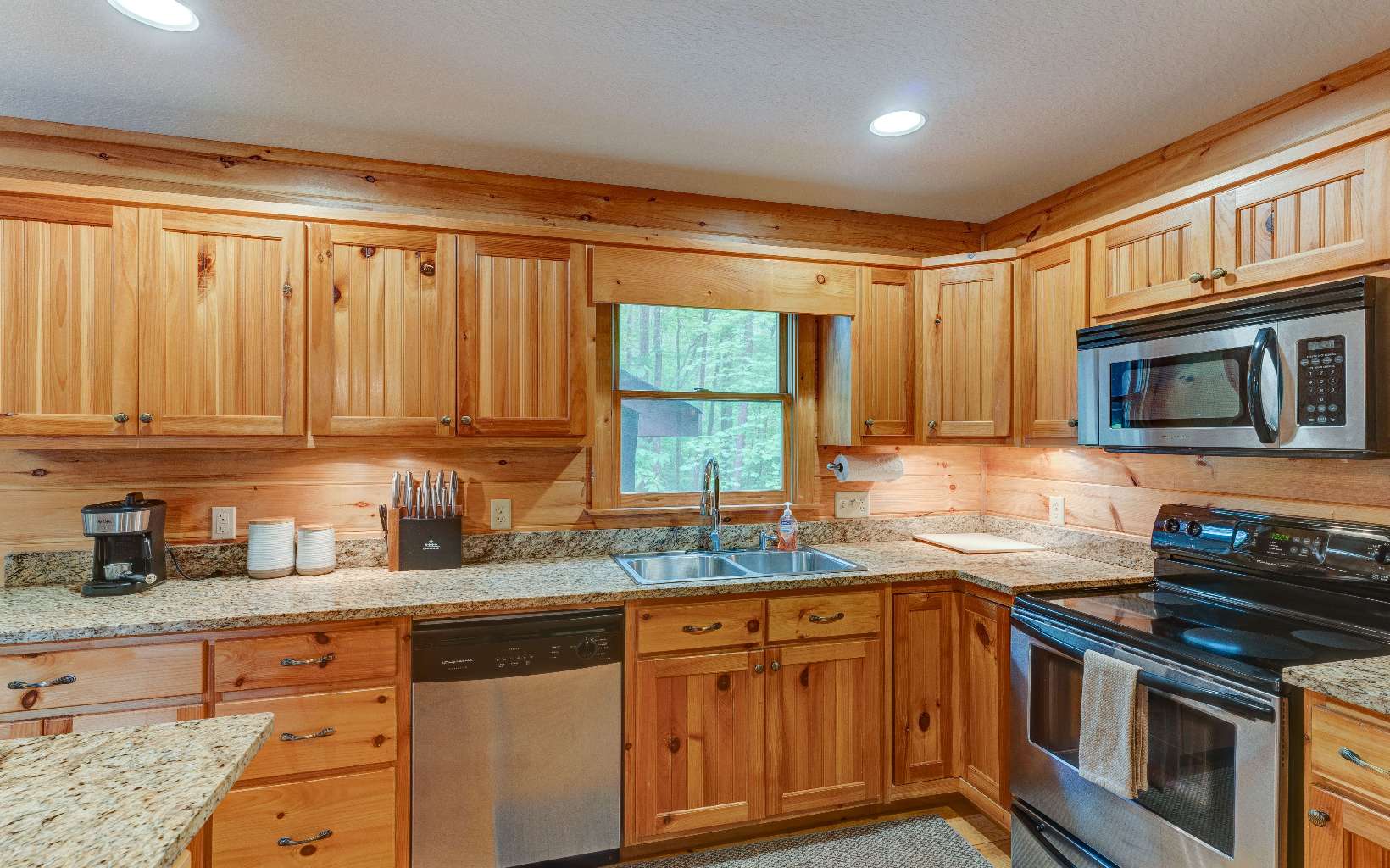 22 Kings Court Ellijay, GA 30540 - Photo 26 of 54 a kitchen with stainless steel appliances granite countertop a stove a sink and a microwave