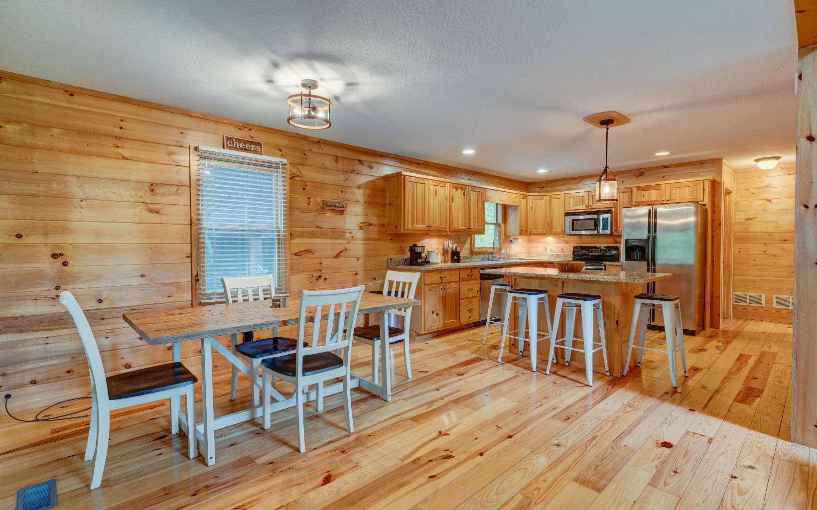 22 Kings Court Ellijay, GA 30540 - Photo 28 of 54 a kitchen with stainless steel appliances kitchen island granite countertop a table chairs and a view of kitchen