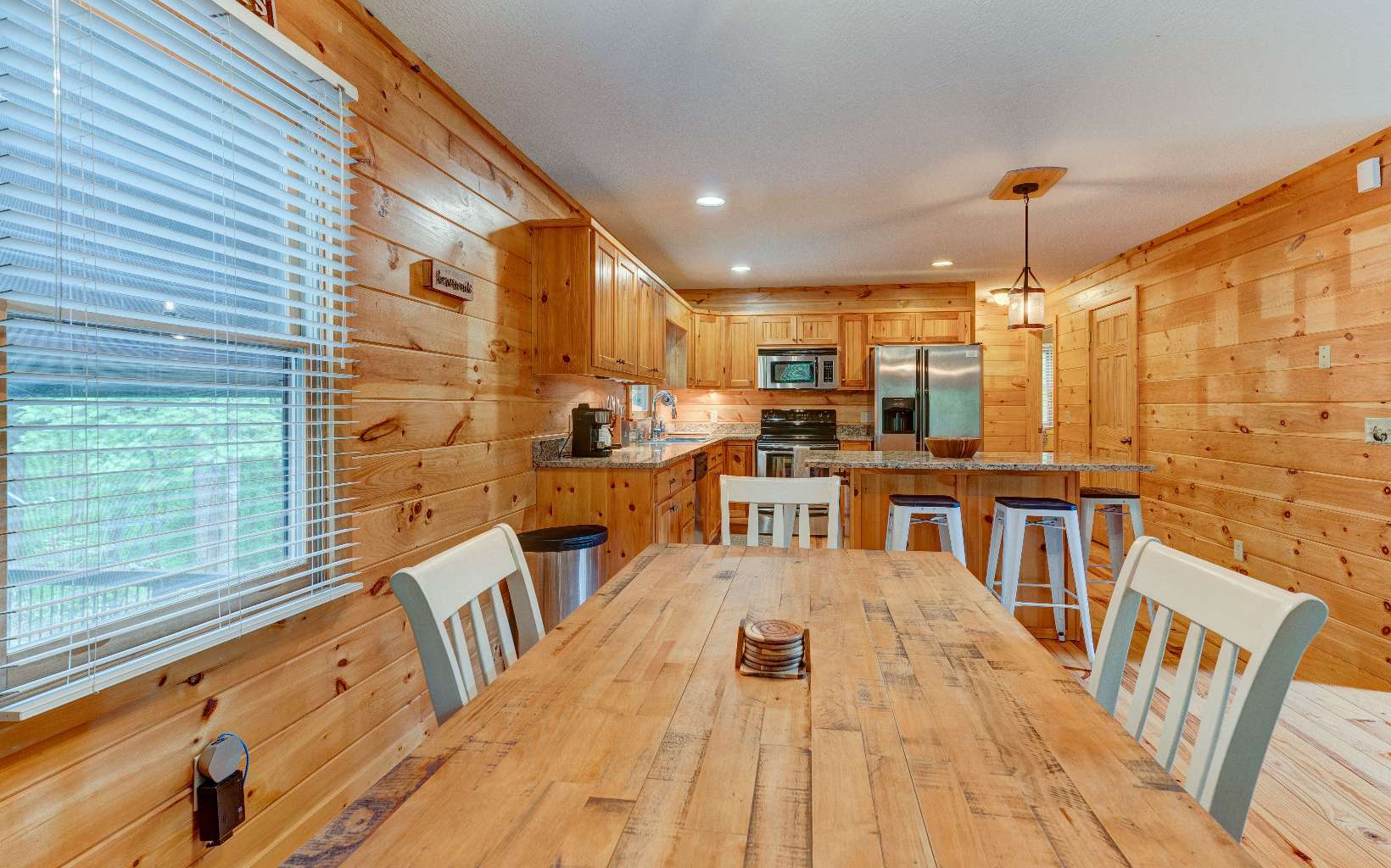 22 Kings Court Ellijay, GA 30540 - Photo 29 of 54 a living room with stainless steel appliances kitchen island granite countertop a refrigerator a stove and a wooden cabinets
