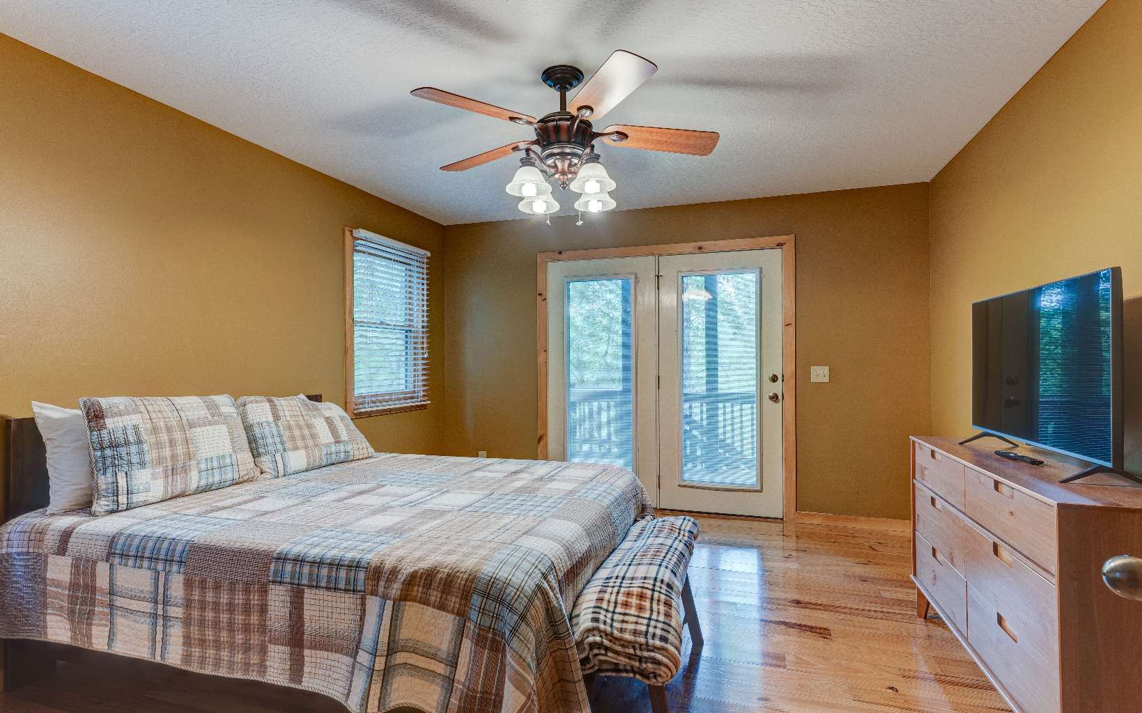 22 Kings Court Ellijay, GA 30540 - Photo 52 of 54 a bedroom with a bed and a chandelier