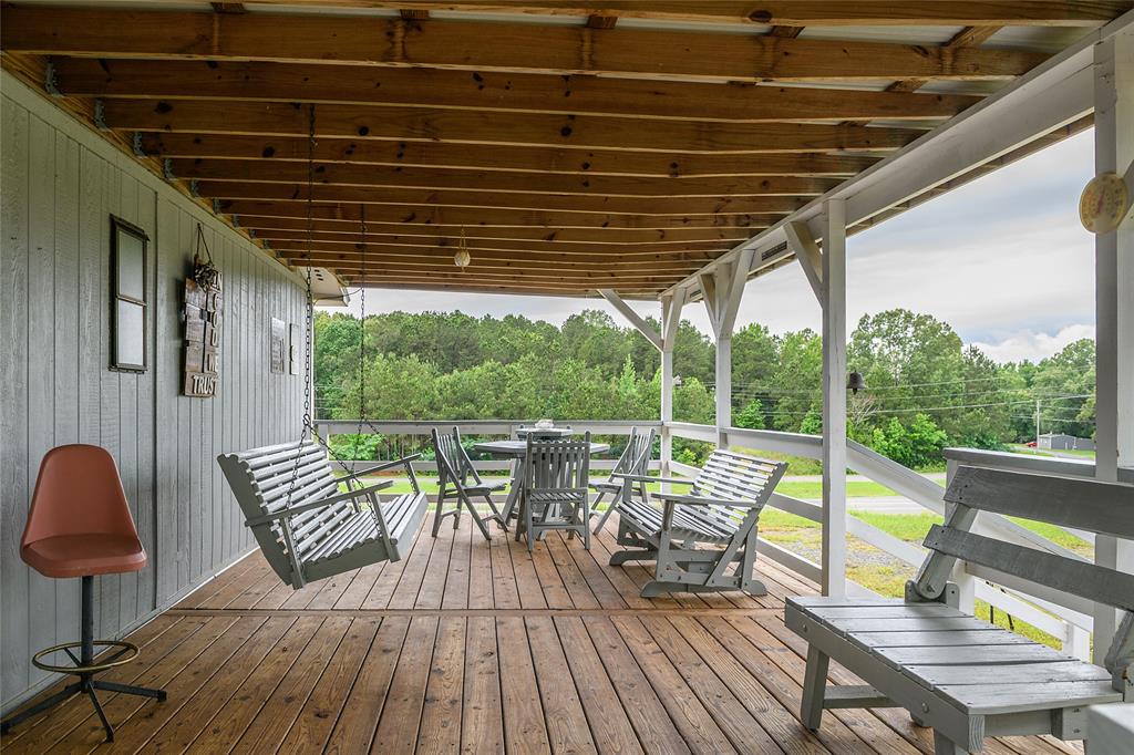 122 Grice Road Ringgold, LA 71068 - Photo 3 of 26 Expansive covered porch featuring wood-finish flooring and a wood beam ceiling