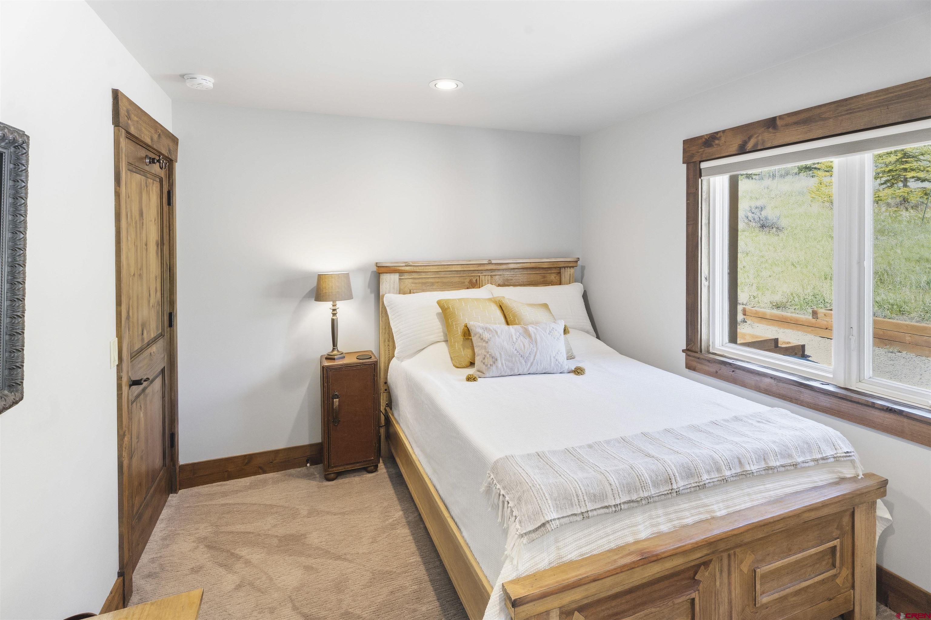 684 Falcon Way Montrose, CO 81403 - Photo 23 of 43 a bedroom with a bed and a large window