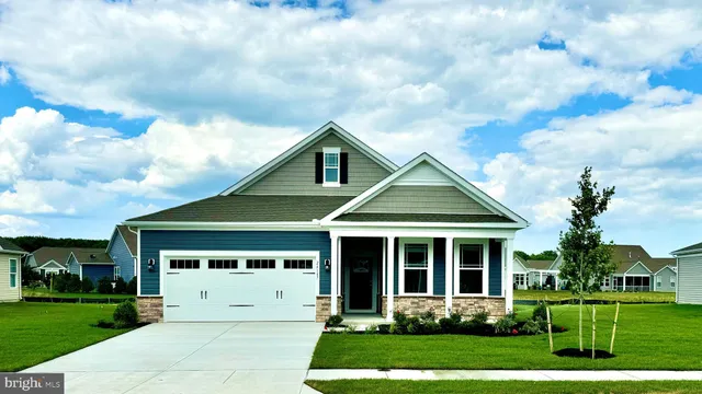 a view of a white house with yard and plants