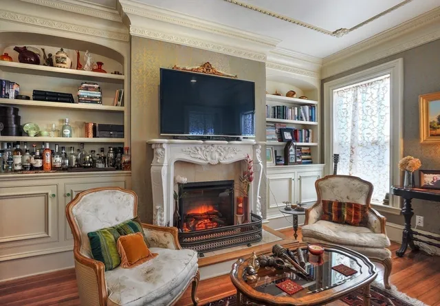 a living room with furniture fireplace and a flat screen tv
