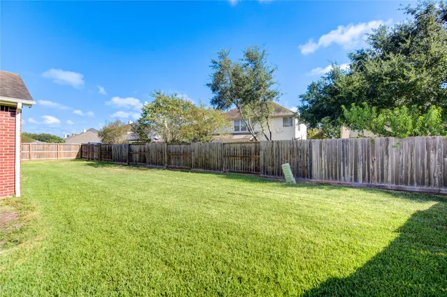 a view of a backyard with a tree