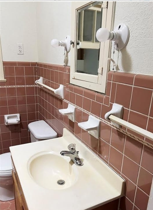 809 North 8th Street Temple, TX 76501 - Photo 12 of 20 Functional bathroom featuring a sink, toilet, and classic tile work.