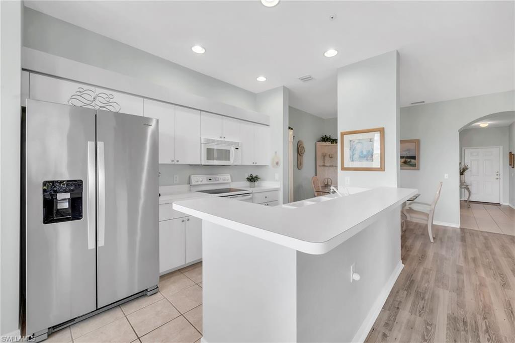 3800 Sawgrass Way, Unit 3142 Naples, FL 34112 - Photo 14 of 50 a kitchen with stainless steel appliances a refrigerator sink and stove