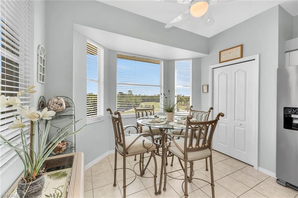 3800 Sawgrass Way, Unit 3142 Naples, FL 34112 - Photo 16 of 50 a view of a dining room with furniture and chandelier