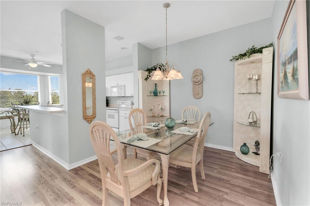 3800 Sawgrass Way, Unit 3142 Naples, FL 34112 - Photo 17 of 50 a view of a dining room with furniture and wooden floor
