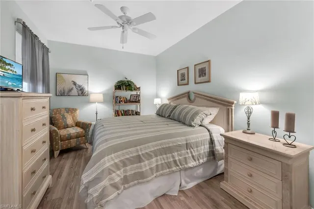 a spacious bedroom with a bed and a chandelier