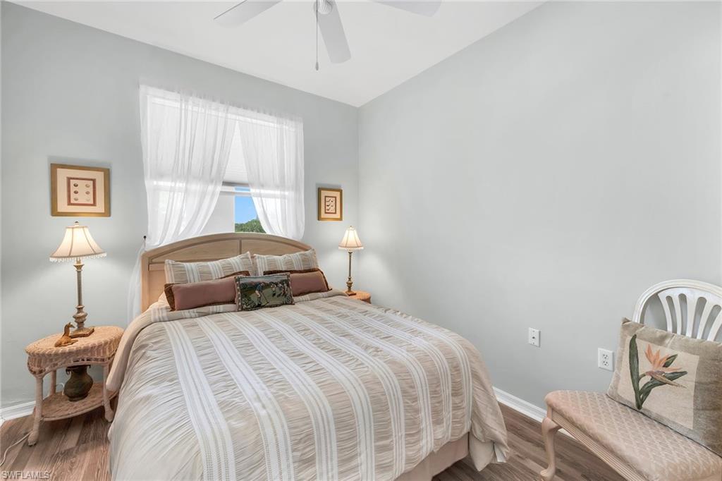 3800 Sawgrass Way, Unit 3142 Naples, FL 34112 - Photo 24 of 50 a bedroom with a bed and wooden floor