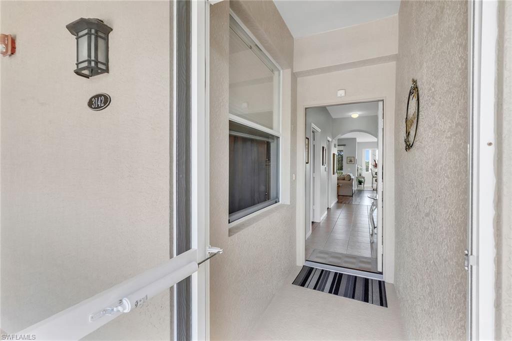 3800 Sawgrass Way, Unit 3142 Naples, FL 34112 - Photo 5 of 50 a view of a hallway with a livingroom and a bathroom with sink