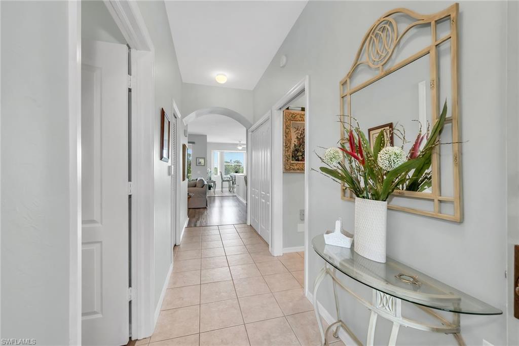 3800 Sawgrass Way, Unit 3142 Naples, FL 34112 - Photo 6 of 50 a view of a hallway with bathroom and mirror
