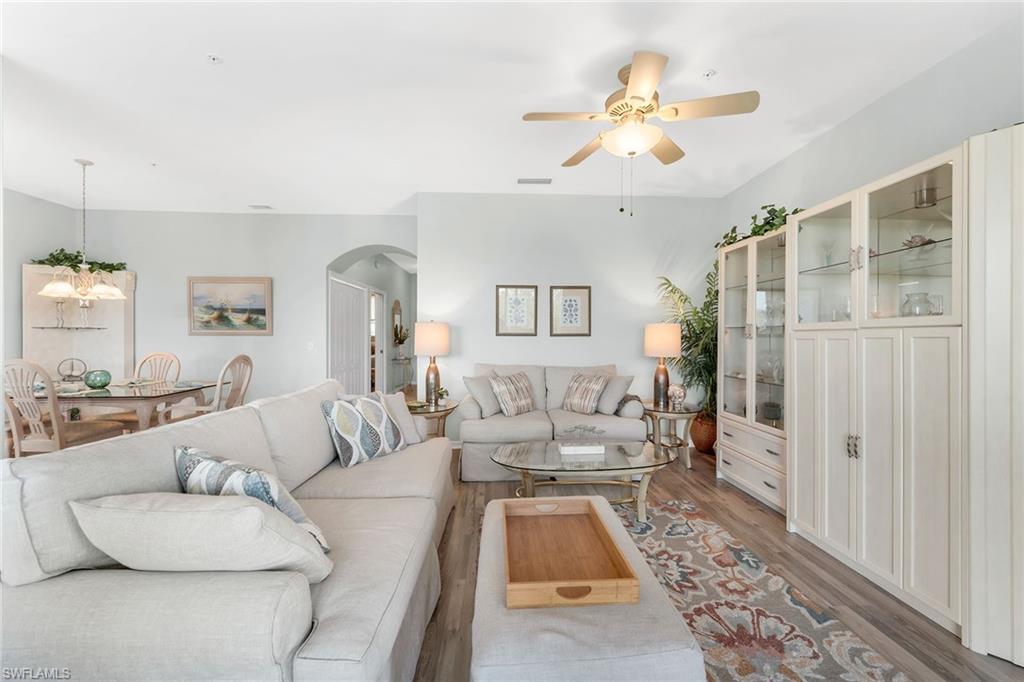 3800 Sawgrass Way, Unit 3142 Naples, FL 34112 - Photo 8 of 50 a living room with furniture and a chandelier