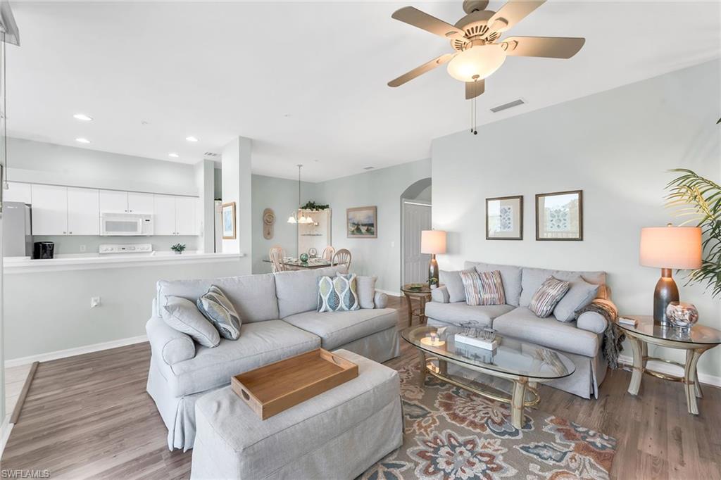 3800 Sawgrass Way, Unit 3142 Naples, FL 34112 - Photo 10 of 50 a living room with furniture and a view of kitchen