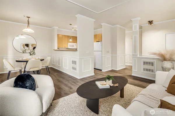 a living room with furniture and wooden floor