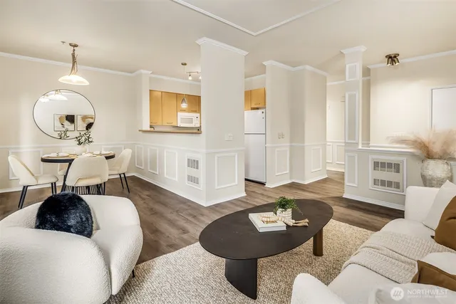 a living room with furniture and wooden floor