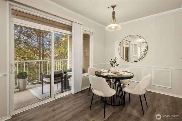 a view of a dining room with furniture window and wooden floor