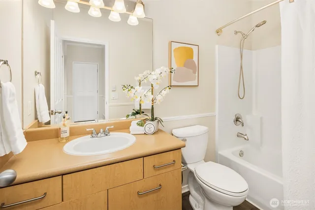 a bathroom with a sink toilet tub and shower