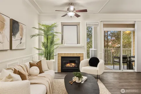 a living room with furniture fireplace and a large window