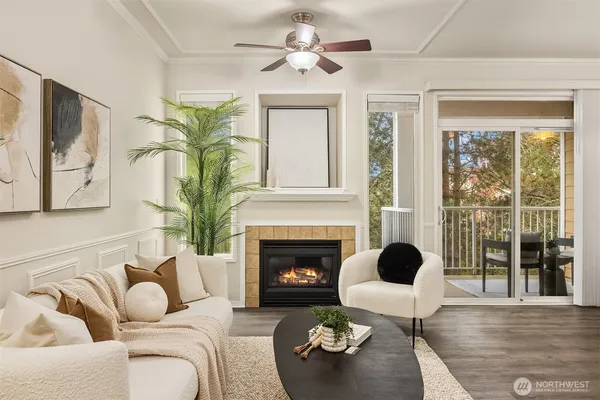 a living room with furniture fireplace and a large window