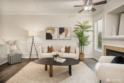 a living room with furniture a chandelier and a fireplace