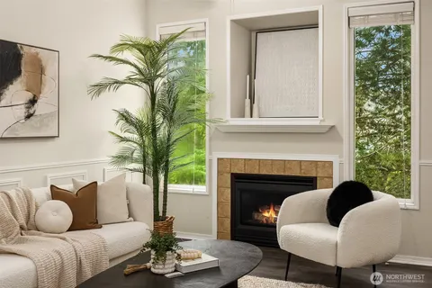 a living room with furniture fireplace and a large window