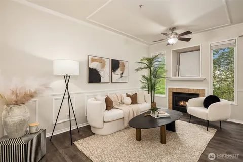 a living room with furniture a table and a potted plant