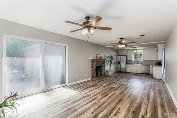 a view of a livingroom with furniture and a kitchen