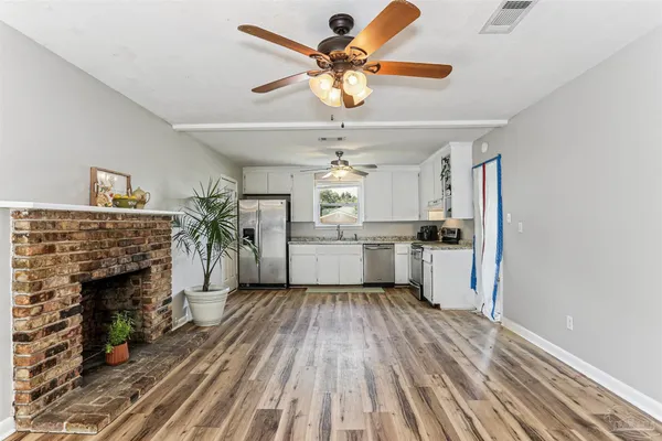 a open kitchen with white cabinets and stainless steel appliances