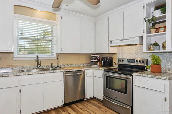 a kitchen with cabinets appliances and a sink