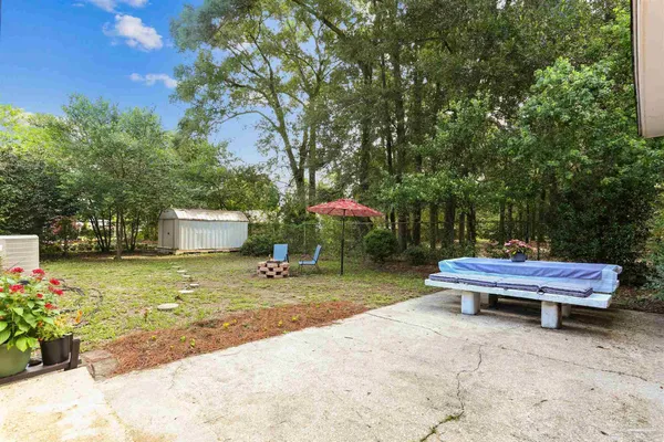 a view of a backyard with sitting area