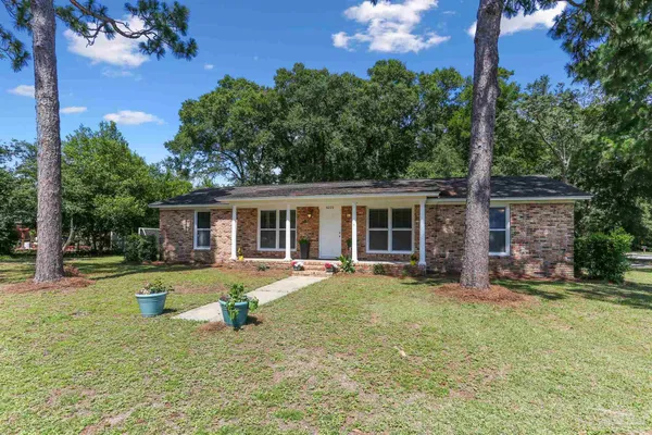 front view of a house with a yard and sitting area