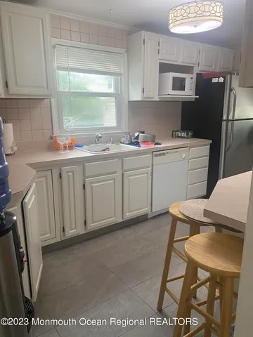 a kitchen with a stove and a white cabinets
