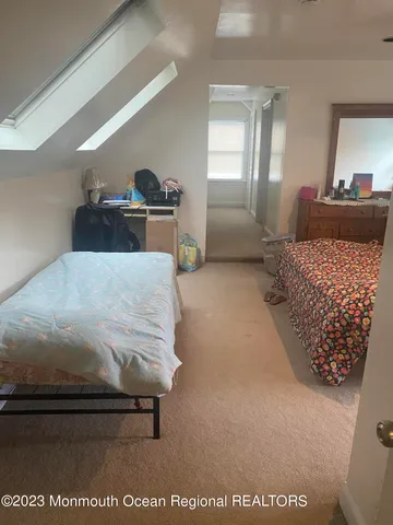 a bedroom with a bed and dresser