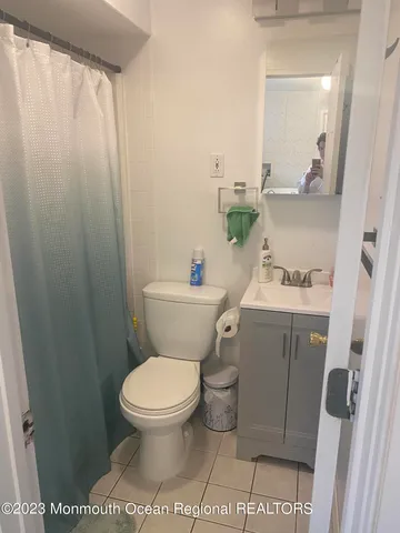 a white toilet sitting next to a bathroom sink