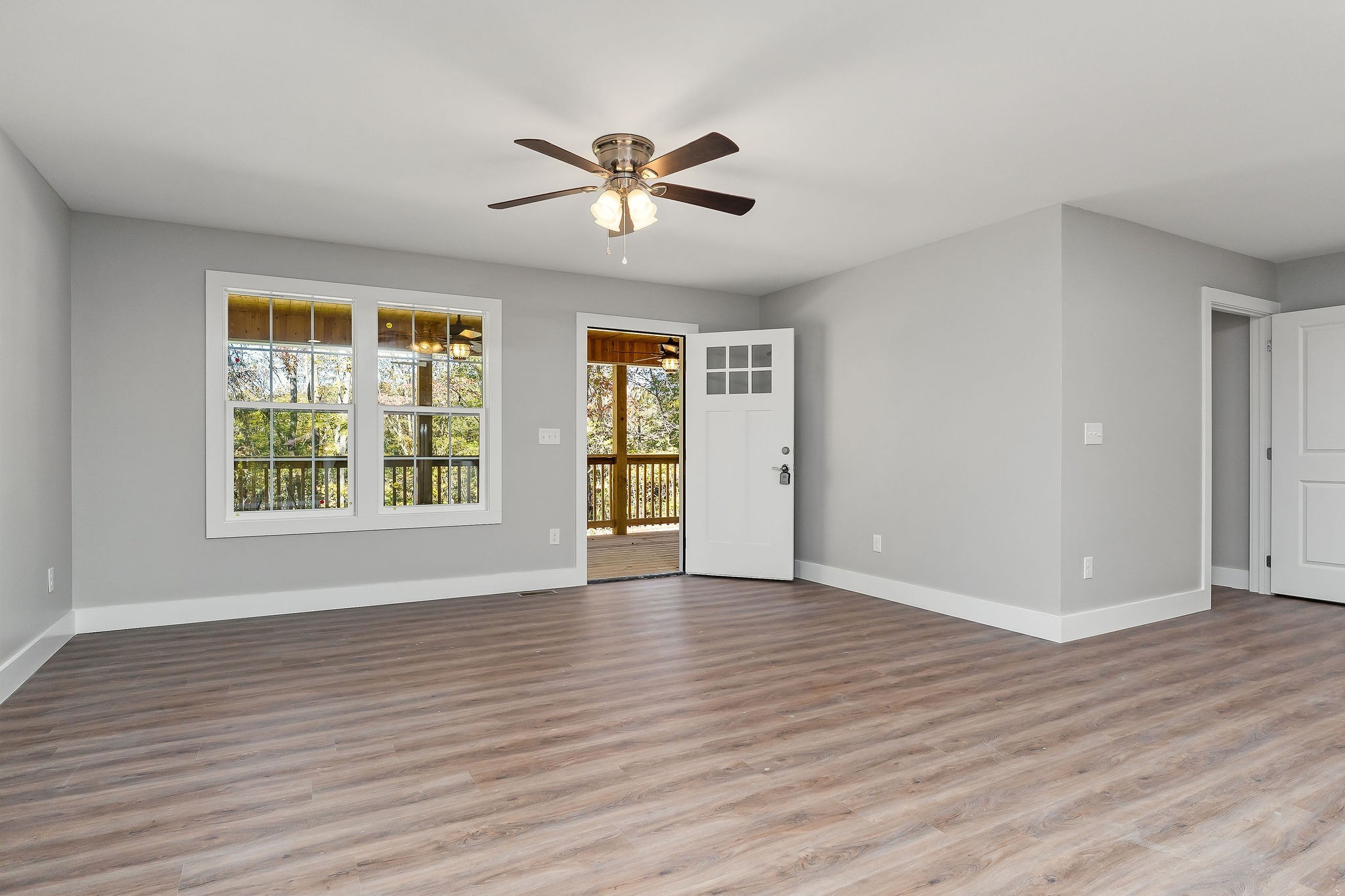1053 Benton Tidwell Road Hilham, TN 38568 - Photo 4 of 39 a view of an empty room with wooden floor and a window