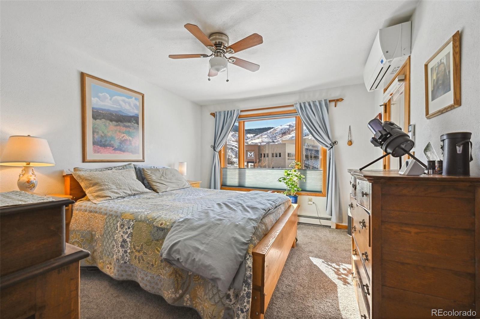 1112 Maple Street Golden, CO 80401 - Photo 12 of 36 a bed room with a bed and a chandelier