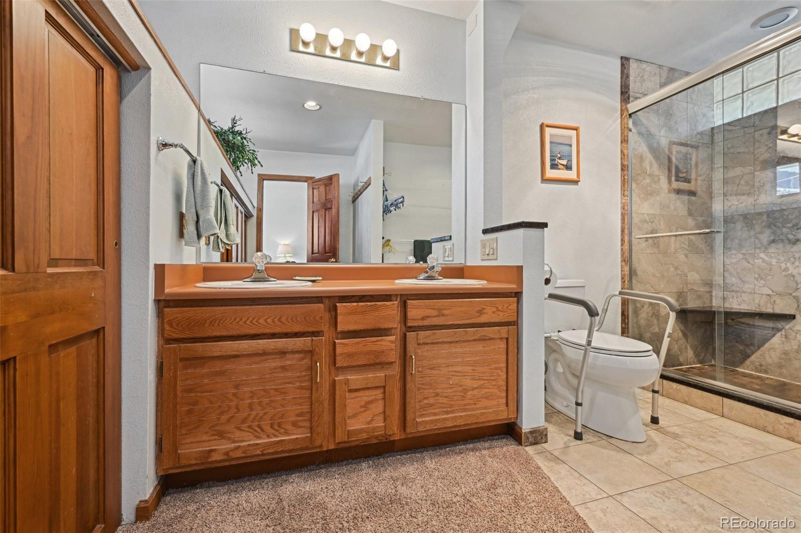 1112 Maple Street Golden, CO 80401 - Photo 14 of 36 a bathroom with a sink and a mirror