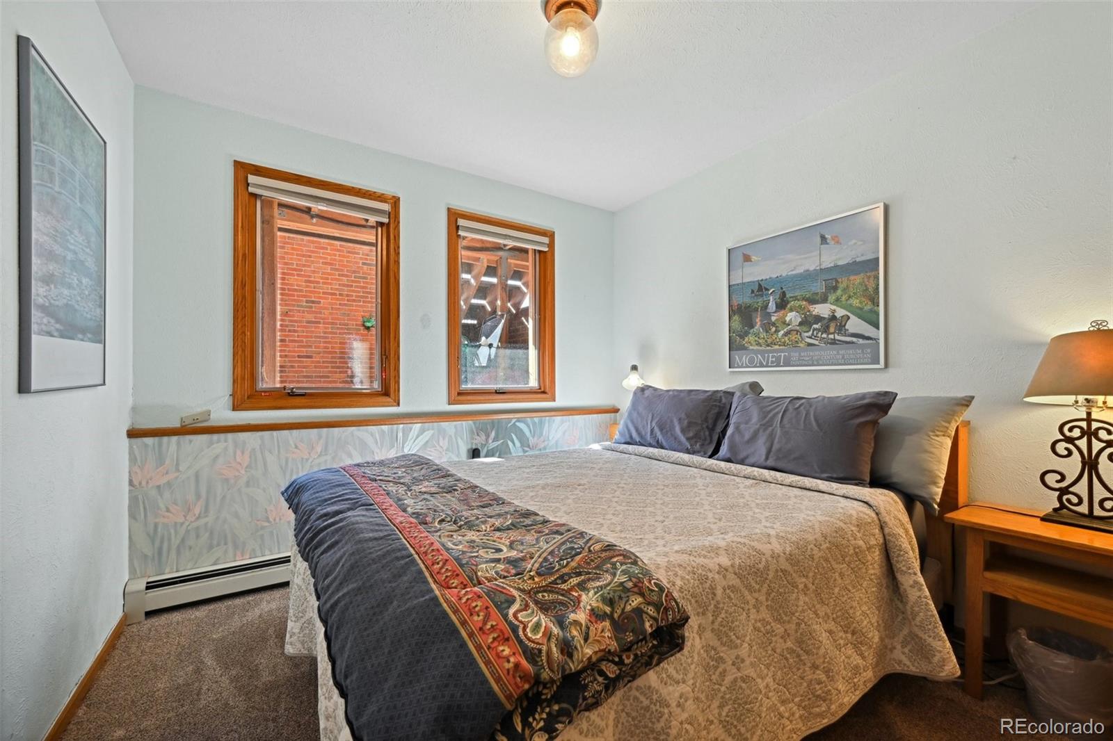 1112 Maple Street Golden, CO 80401 - Photo 22 of 36 a bedroom with a bed and a painting on the wall