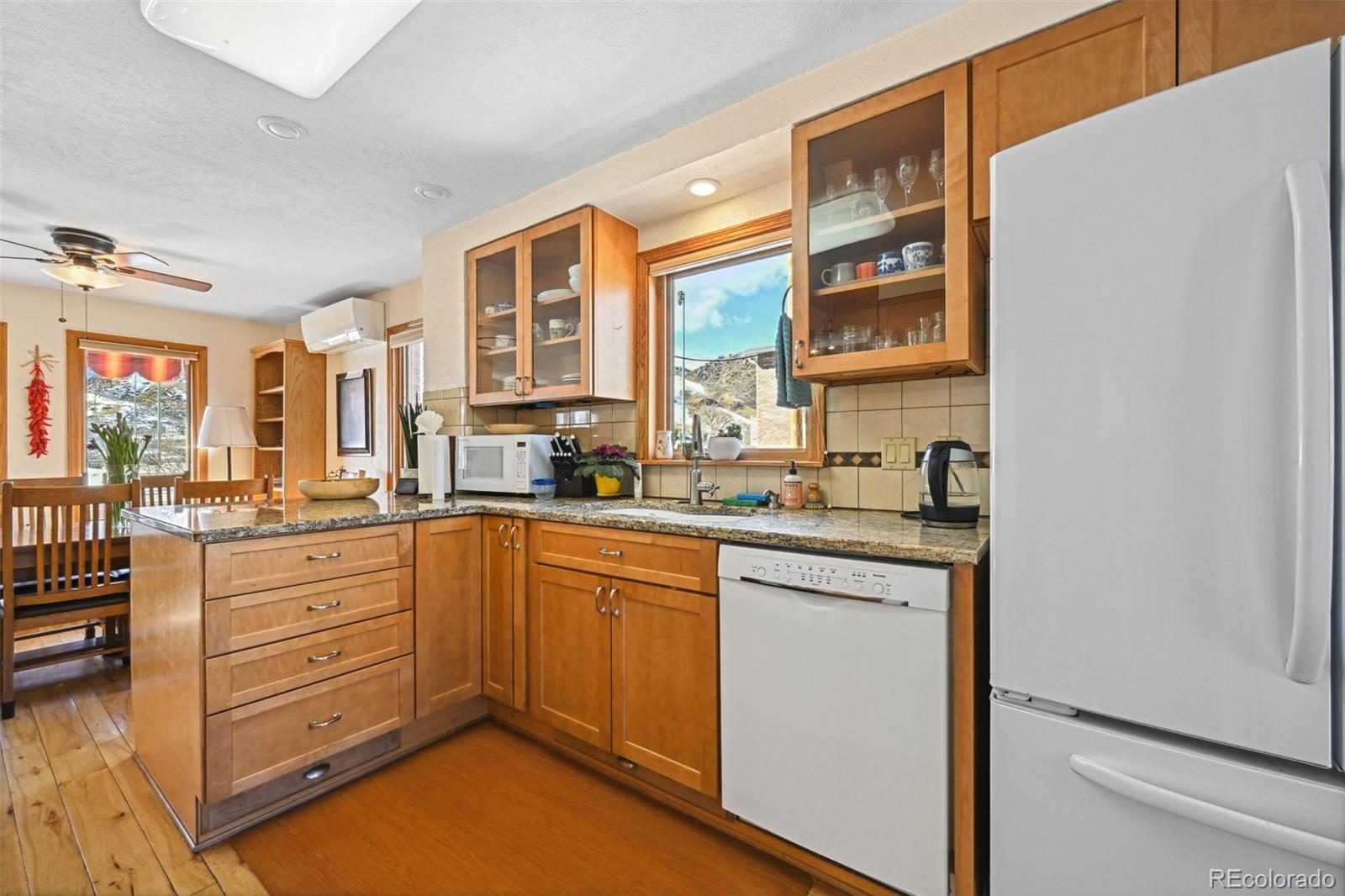 1112 Maple Street Golden, CO 80401 - Photo 10 of 36 a kitchen with stainless steel appliances granite countertop a stove and a sink