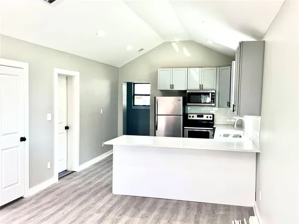 a kitchen with stainless steel appliances a refrigerator and a stove