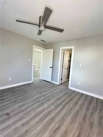 a view of an empty room and wooden floor