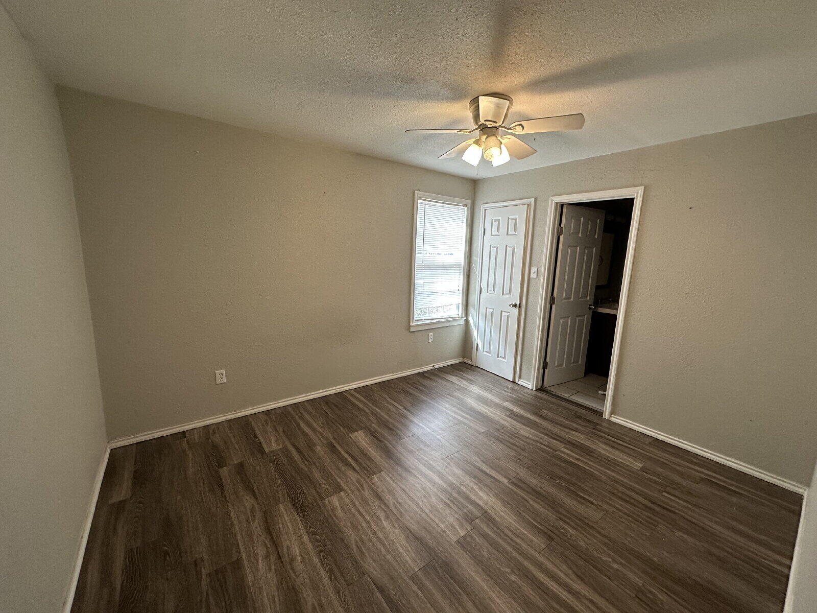 2513 29th Street Lubbock, TX 79410 - Photo 13 of 15 a view of an empty room with wooden floor and a window