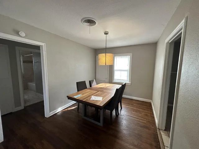 a view of a room with furniture wooden floor and chandelier