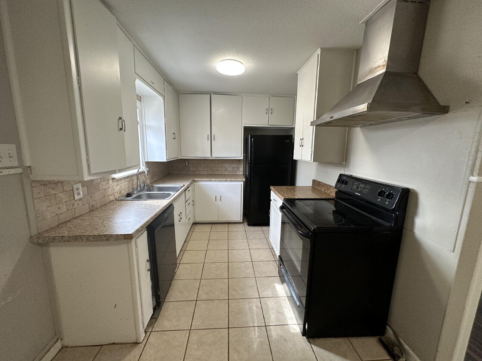 2513 29th Street Lubbock, TX 79410 - Photo 5 of 15 a kitchen with a sink a stove top oven and refrigerator