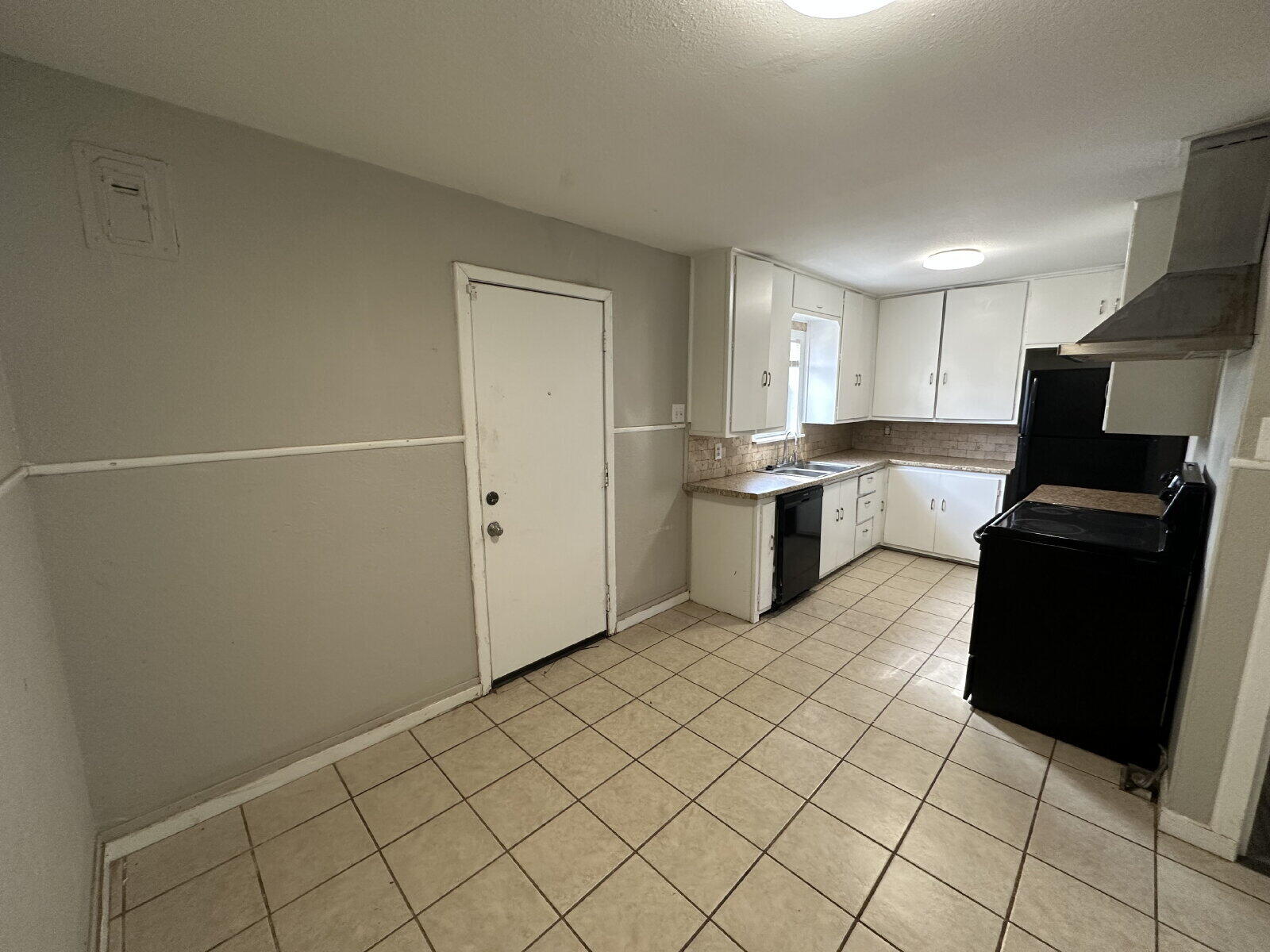 2513 29th Street Lubbock, TX 79410 - Photo 6 of 15 a kitchen with a sink a stove top oven and cabinetry