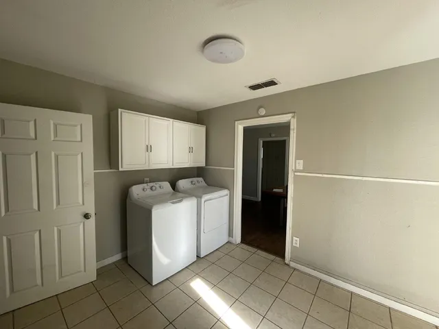 a view of a utility room with closet and windows