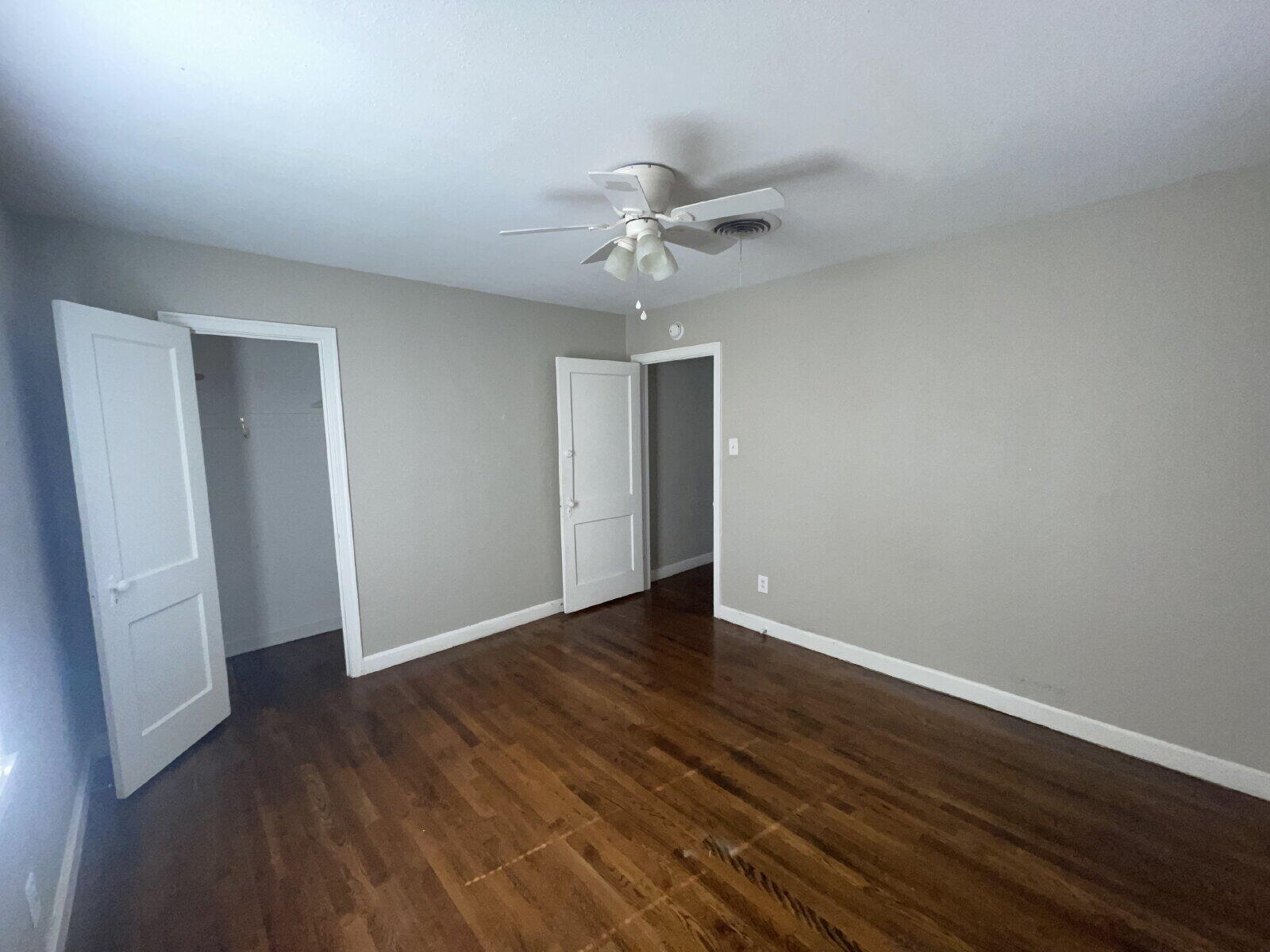 2513 29th Street Lubbock, TX 79410 - Photo 8 of 15 an empty room with wooden floor and ceiling fan